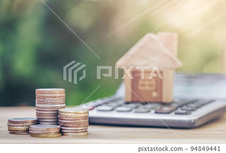 Coins and a calculator placed on the table. concept of calculation in saving money. Coins and a calculator placed on the table. concept of calculation in saving money. 94849441