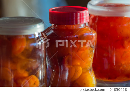Glass jars with apple jam. Home canning. Delicious dessert for tea. Cooking 94850438