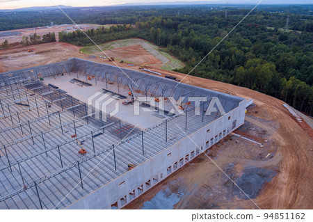 During the construction of a steel warehouse, the roof truss frame was installed on an industrial building During the construction of a steel warehouse, the roof truss frame was installed on an industrial building 94851162