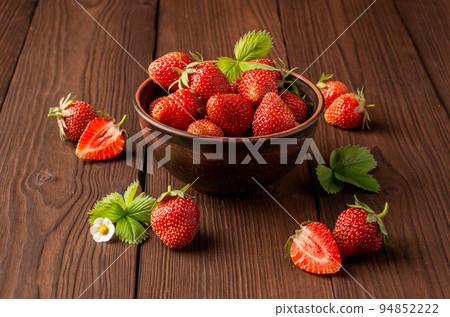 fresh strawberries in a plate on a wooden table 94852222