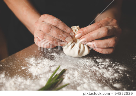 Khinkali cooking process close up. Chef hands sculpt khinkali. 94852829