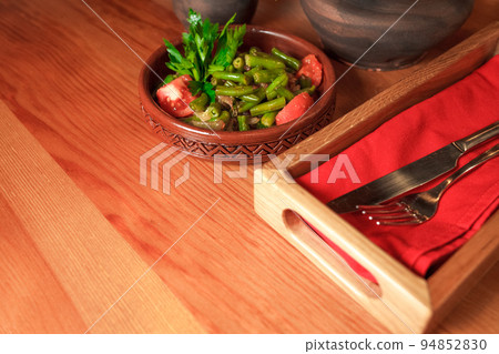 Georgian green bean dish on a table of a restaurant. Dish of Georgian cuisine Georgian green bean dish on a table of a restaurant. Dish of Georgian cuisine 94852830