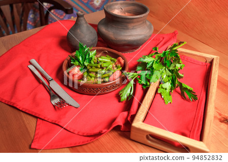Georgian green bean dish on a table of a restaurant. Dish of Georgian cuisine Georgian green bean dish on a table of a restaurant. Dish of Georgian cuisine 94852832