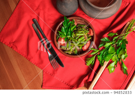 Georgian green bean dish on a table of a restaurant. Dish of Georgian cuisine. 94852833