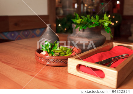 Georgian green bean dish on a table of a restaurant. Dish of Georgian cuisine.. Georgian green bean dish on a table of a restaurant. Dish of Georgian cuisine.. 94852834