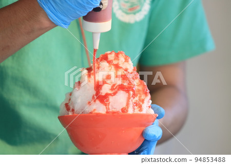 Large serving of shaved ice Shaved ice with plenty of strawberry syrup Large serving of shaved ice Shaved ice with plenty of strawberry syrup 94853488
