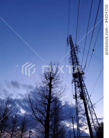 Winter sky moon and steel tower 94854350