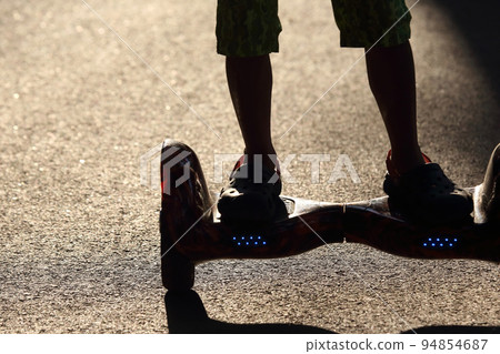 silhouette riding on a segway 94854687
