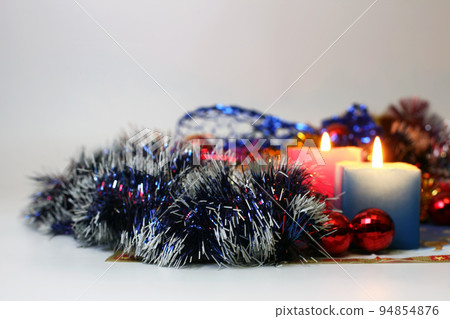 two burning candles with new year decoration 94854876