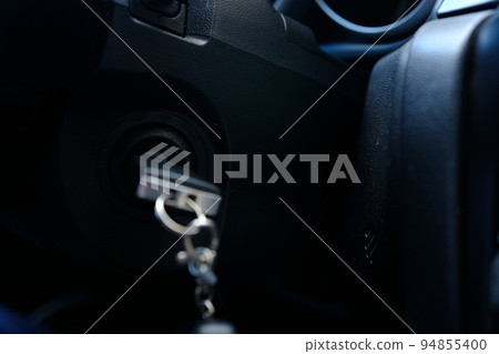 Ignition key of modern car close up. Car key in keyhole 94855400