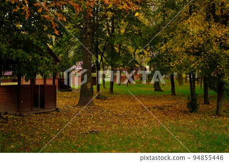 Wooden gazebos in the park on an autumn day no people,summerhouse in the forest with wonderful autumn orange red and yellow colored foliage leafs, Autumn recriation concept 94855446