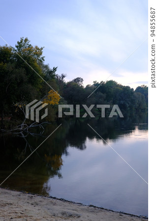 Autumn fall in park with yellow leaves trees and lake 94855687