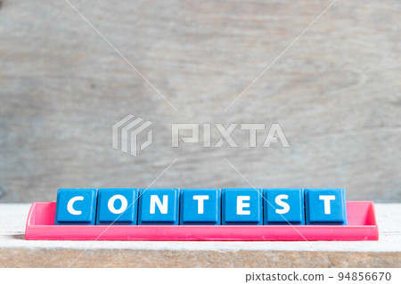 Tile alphabet letter with word contest in red color rack on wood background 94856670