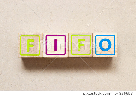 Color letter block in word FIFO (Abbreviation of first in first out) on wood background 94856698