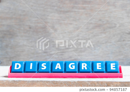 Tile alphabet letter with word disagree in red color rack on wood background 94857187
