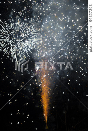 Fireworks in evening sky during celebration for New Year Fireworks in evening sky during celebration for New Year 94857298