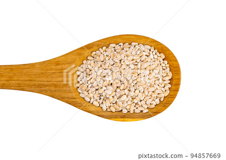 Top view or flat lay group of dry pearl barley in wooden spoon isolated on white background. 94857669