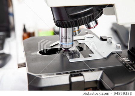 Microscope slide with pap smear sample on the microscope for scientist diagnosis at cytology or pathology department. Cervical cancer concept. Medical concept. 94859388