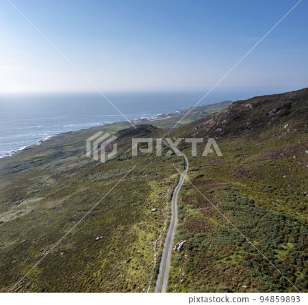 Aerial view of the coastal single track road between Meenacross and Crohy Head south of Dungloe, County Donegal - Ireland Aerial view of the coastal single track road between Meenacross and Crohy Head south of Dungloe, County Donegal - Ireland 94859893