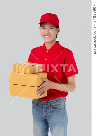 Young asian man in uniform red and cap standing carrying box stack isolated. 94859907