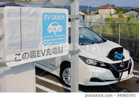 Electric car under charge Electric car under charge 94860305