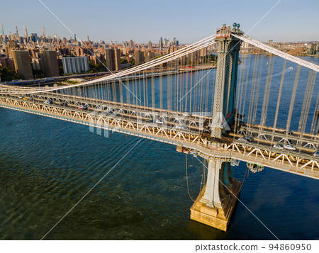 Aerial view of Manhattan from above, with Manhattan Bridge in the foreground and Hudson River in the background Aerial view of Manhattan from above, with Manhattan Bridge in the foreground and Hudson River in the background 94860950