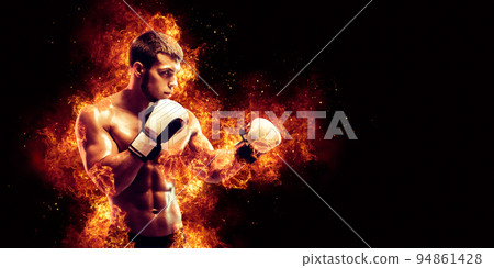 Fighter man punching in fire 94861428