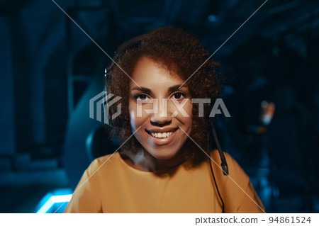 Young curly woman in headphones. 94861524