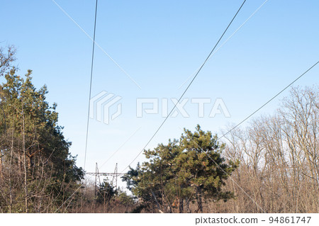 Electric wires and high voltage power lines on the background of sky and nature Electric wires and high voltage power lines on the background of sky and nature 94861747