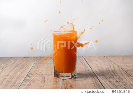 Orange juice is sprayed from a glass. Spray a sweet drink. A splash of fruit juice. Orange juice is sprayed from a glass. Spray a sweet drink. A splash of fruit juice. 94861846