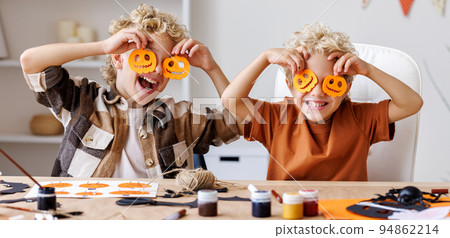 Cute children boys making Halloween home decorations Cute children boys making Halloween home decorations 94862214
