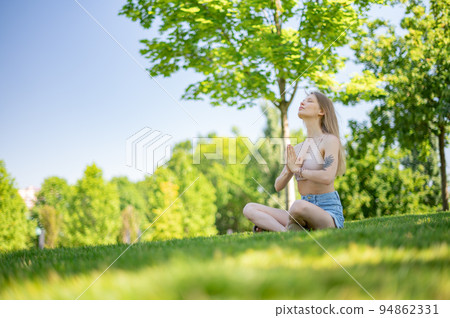 Girl practice yoga meditation outdoor in park Girl practice yoga meditation outdoor in park 94862331