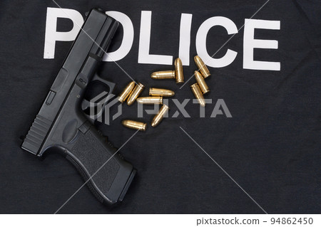Police black uniform and hahdgun with cartidges background Police black uniform and hahdgun with cartidges background 94862450
