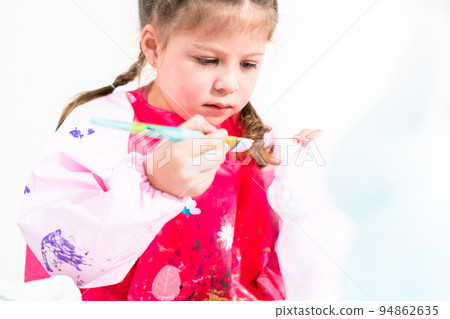 Little girl working on her art project for distance learning at home during COVID-19 pendemic. 94862635