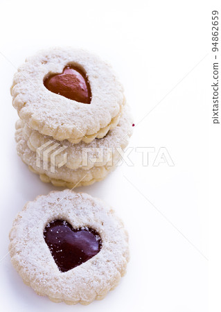 Linzer Torte cookies on white background with powdered sugar sprinkled on top. Linzer Torte cookies on white background with powdered sugar sprinkled on top. 94862659