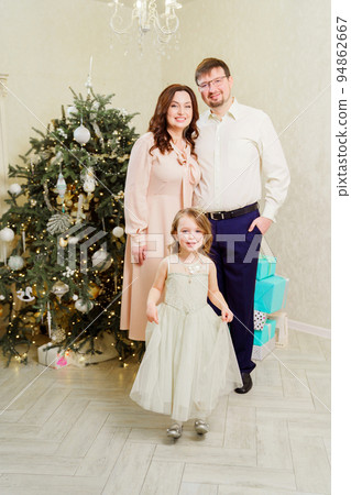 happy family by Christmas tree. tradition of celebrating new year at home 94862667