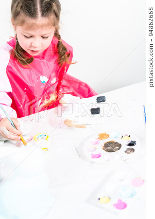 Little girl working on her art project for distance learning at home during COVID-19 pendemic. 94862668