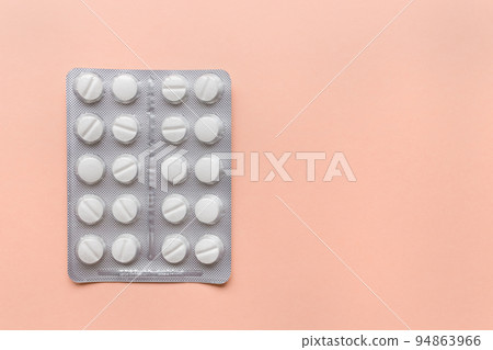 Full blister pack of pills on yellow background, supplement and medicine concept. Closeup, top view, frame, copy space Full blister pack of pills on yellow background, supplement and medicine concept. Closeup, top view, frame, copy space 94863966