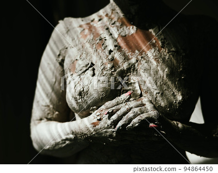 Women's naked breasts covered with plaster like a statue. Women's naked breasts covered with plaster like a statue. 94864450