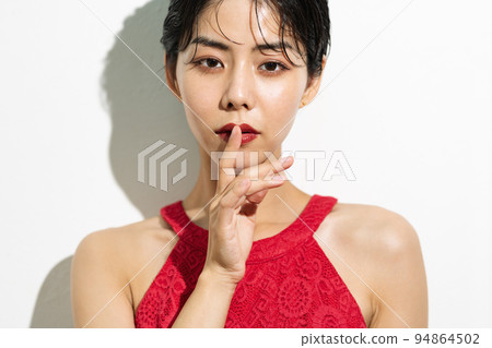 Young woman with short hair in a red dress 94864502