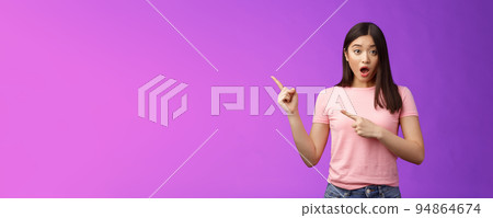 Shocked upset speechless cute asian girl react stunned friend got expensive car, drop jaw astonished, look camera full disbelief, pointing left, discuss astonishing news, stand purple background Shocked upset speechless cute asian girl react stunned friend got expensive car, drop jaw astonished, look camera full disbelief, pointing left, discuss astonishing news, stand purple background 94864674