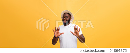 Portrait shock and annoyed displeased young man raising hands up to say no stop right there isolated orange background. Negative human emotion, facial expression, sign, symbol, body language Portrait shock and annoyed displeased young man raising hands up to say no stop right there isolated orange background. Negative human emotion, facial expression, sign, symbol, body language 94864873