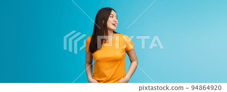 Friendly outgoing stylish female student hanging around friends talking lively enjoy summer party near pool turn left answer question hear someone calling name, smiling joyfully stand carefree 94864920