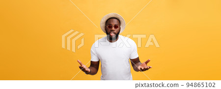 Young african american man wearing white t-shirt shouting and screaming loud to side with hand on mouth. Communication concept. 94865102