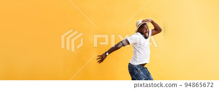 Full length of handsome young black man jumping against yellow background. Full length of handsome young black man jumping against yellow background. 94865672