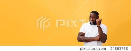Young Stressed man with hand on his face showing sadness and despair. Isolated over yellow background. 94865758