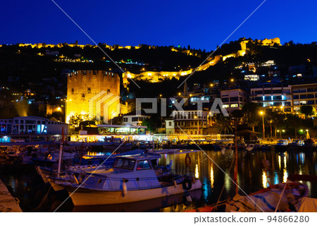 Night view of Alanya cityscape from harbor pier overlooking Red Tower and Castle Night view of Alanya cityscape from harbor pier overlooking Red Tower and Castle 94866280