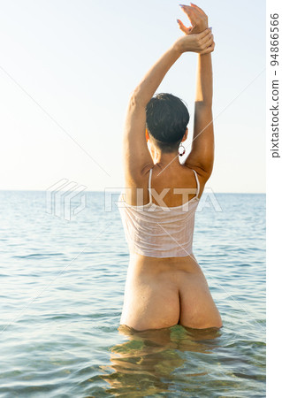 Tempting half-naked brunette posing in shallow water 94866566