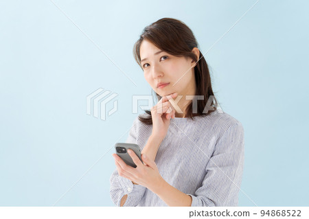 Woman holding a smartphone Woman holding a smartphone 94868522