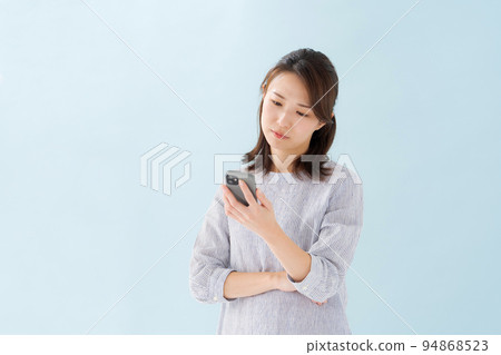 Woman holding a smartphone Woman holding a smartphone 94868523
